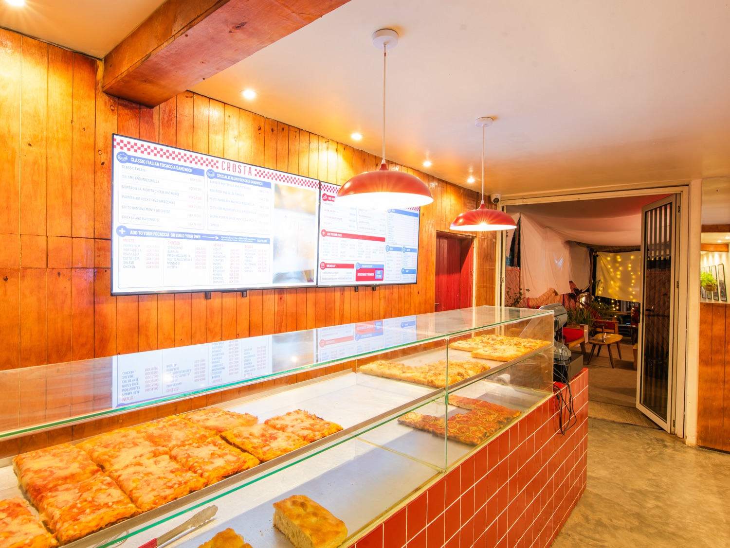 The Crosta counter, with trays of focaccia and pizza al taglio behind the glass